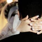man in black shirt covering face with white textile
